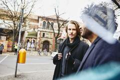 Two men walking on the streets.