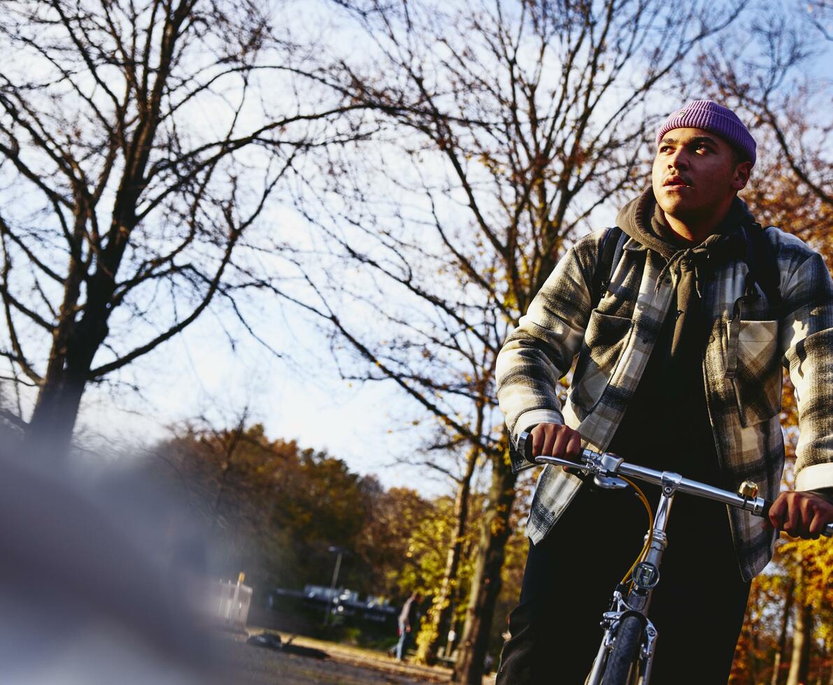 Cycling man, autumn trees on the background.