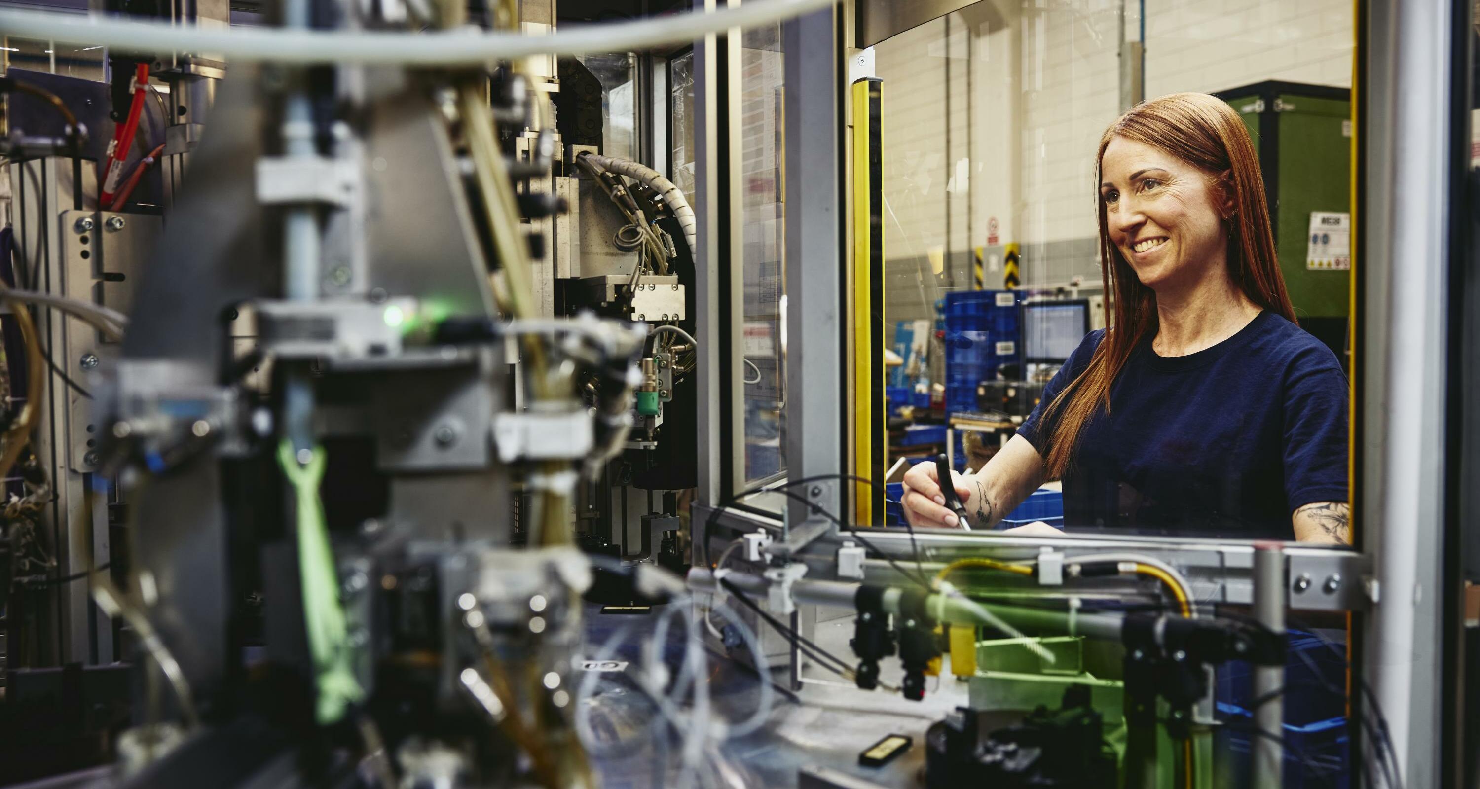 Woman operating a machine on a production site. 