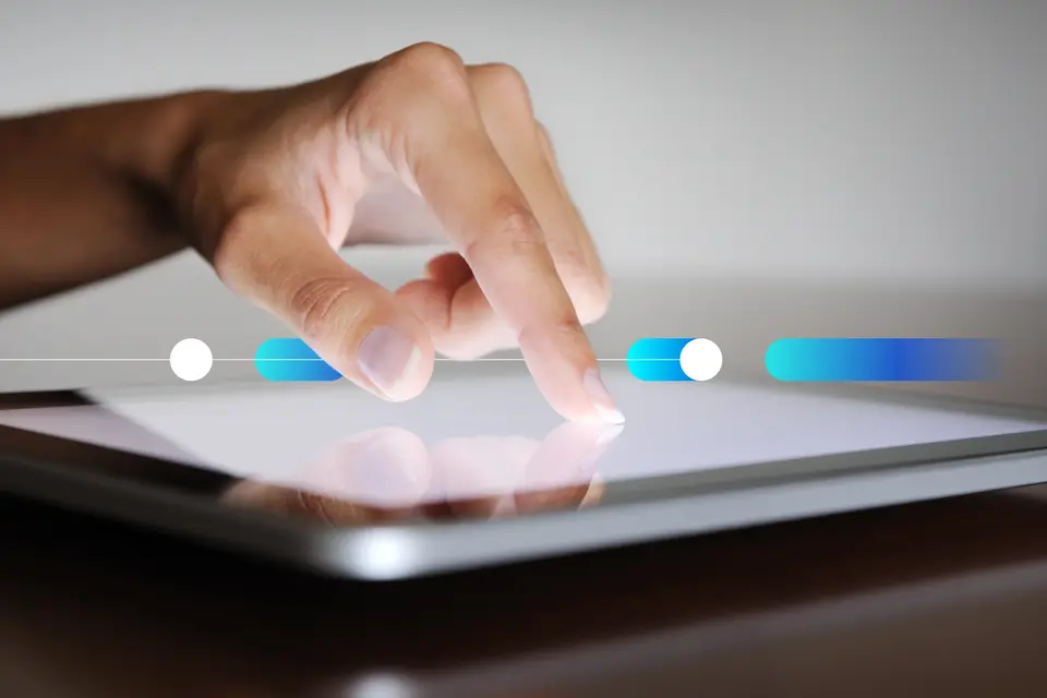 Natural manicured finger pointing on a digital tablet