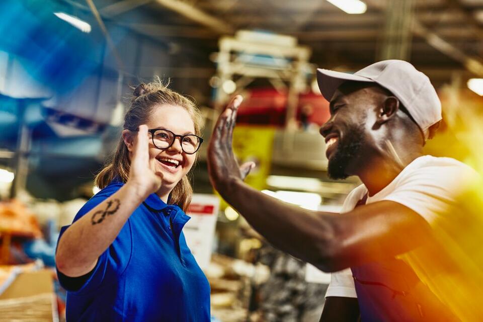 man giving woman a high five