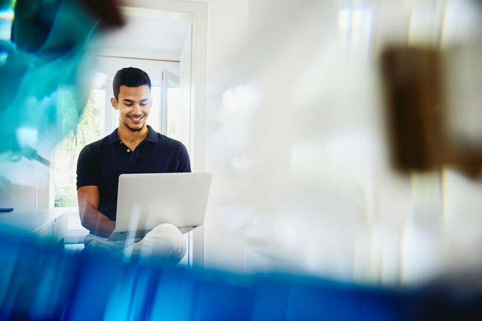 man working behind laptop